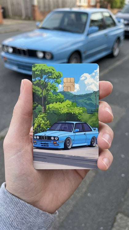 A personalized car card sticker held up, blue 80s coupe